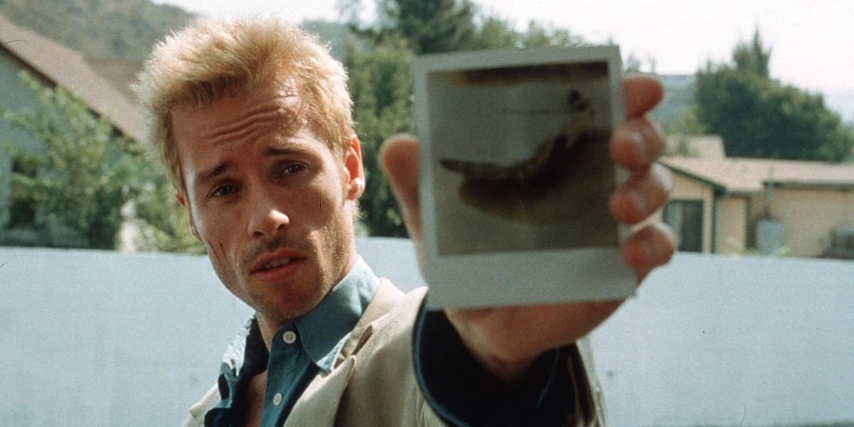 Leonard Shelby examining a Polaroid in Memento
